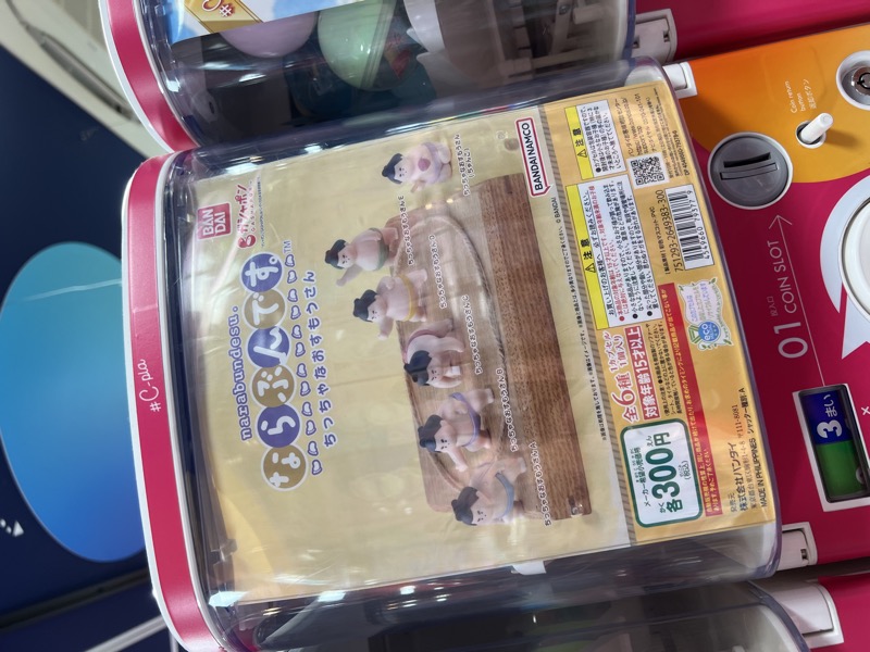 Bandai sumo wrestler gacha figure series displayed in a capsule machine
