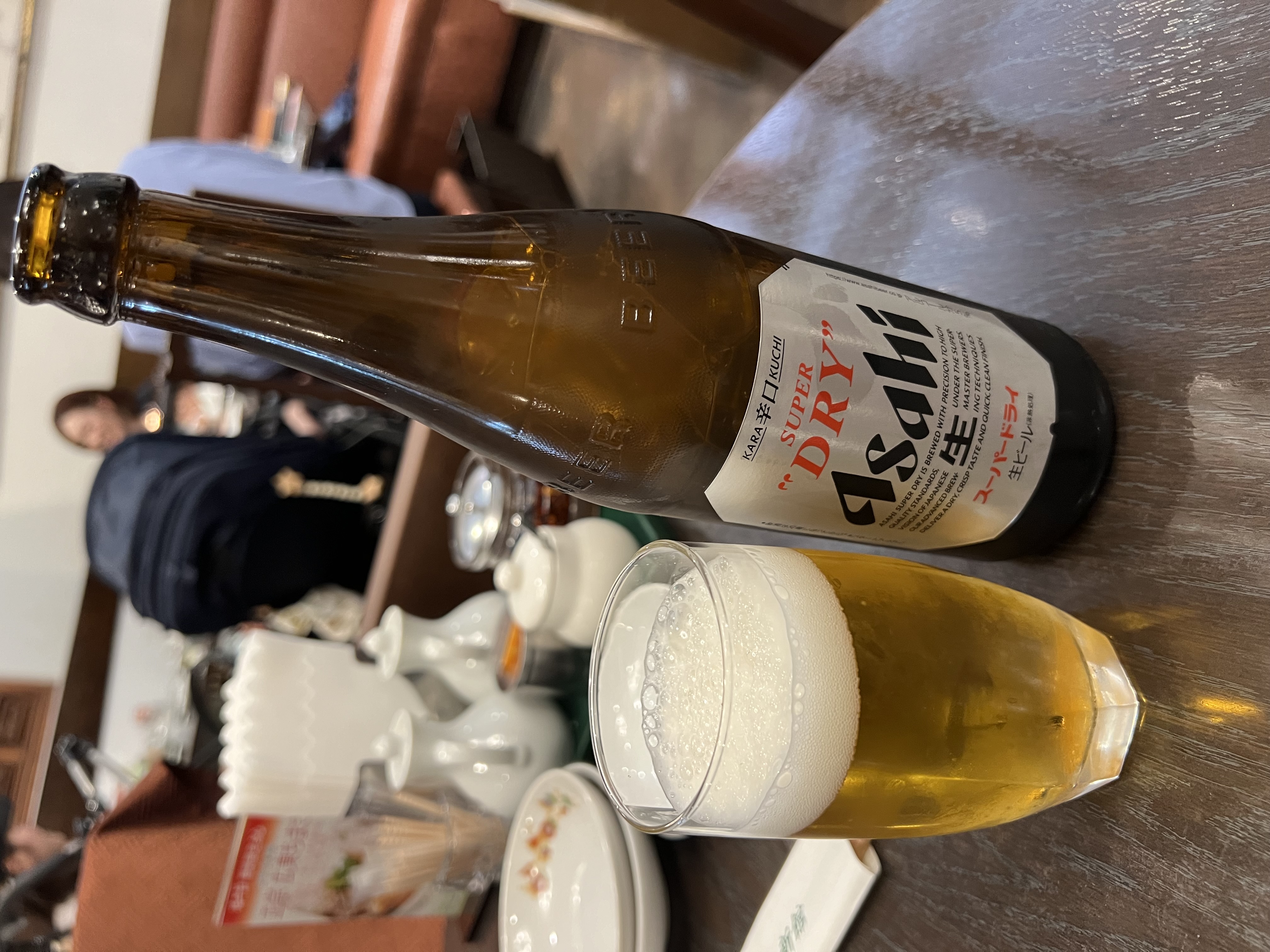Asahi Super Dry bottle and glass on the table