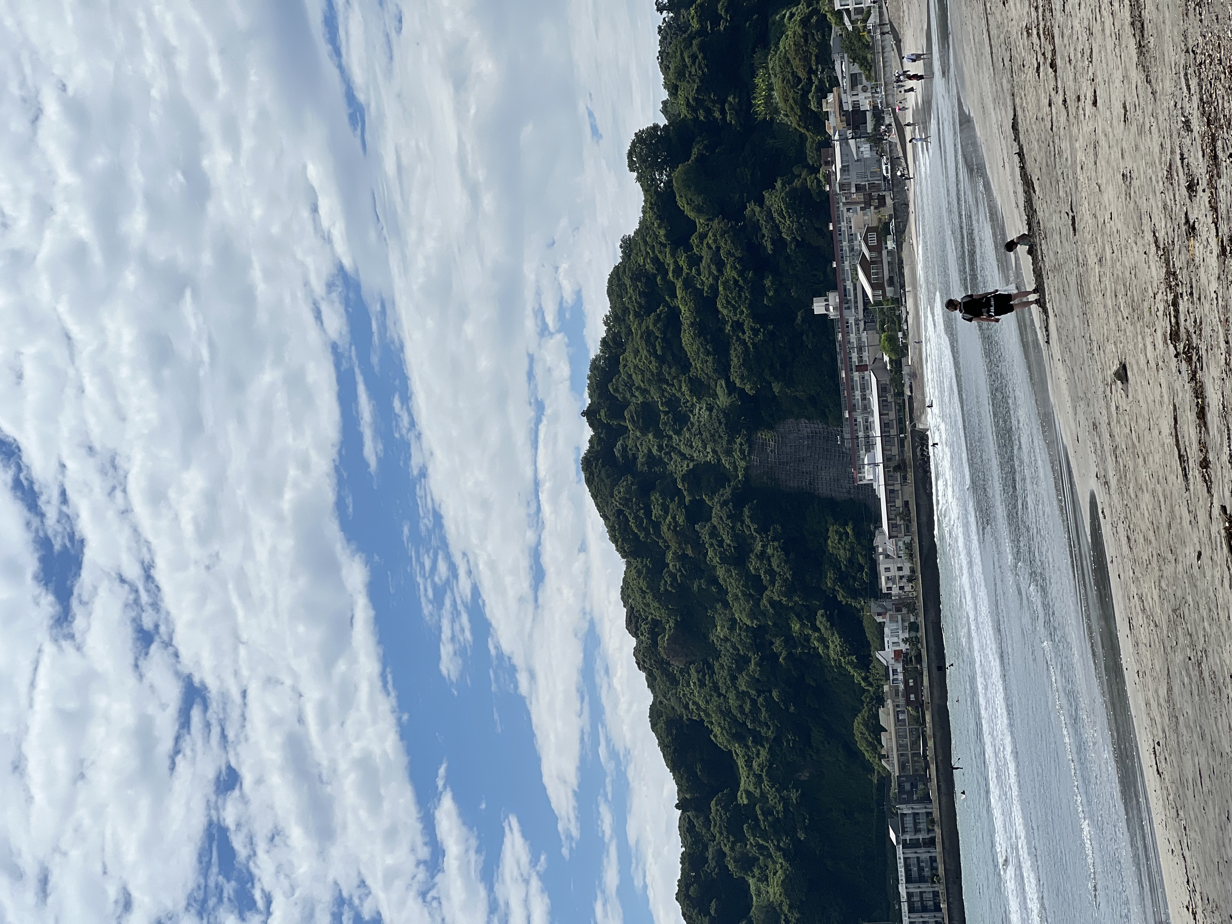 Kamakura beach and coastline on a sunny day with blue skies and scattered cloud