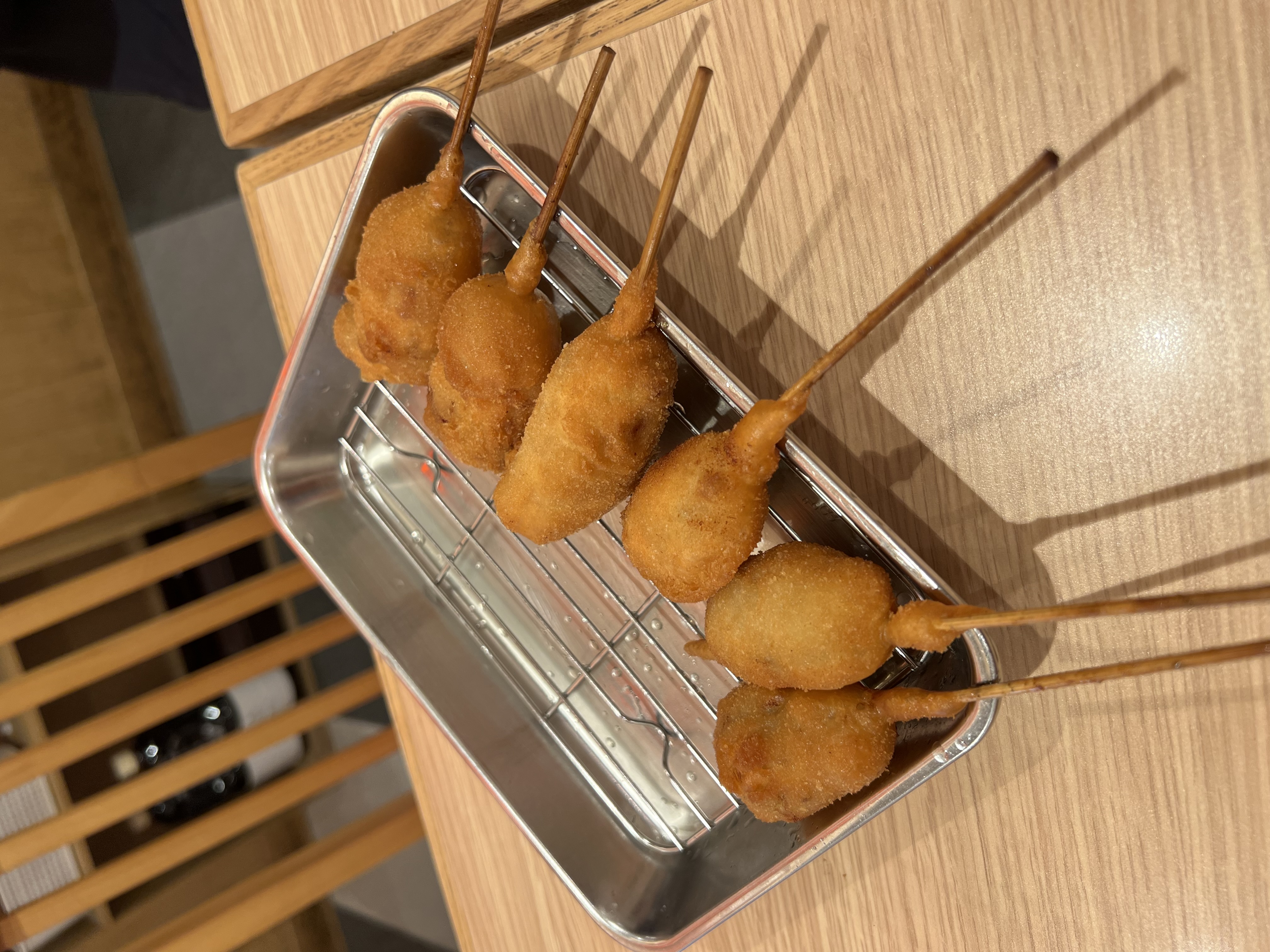 Kushikatsu skewers on a metal rack tray